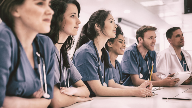 Medical,Students,Listening,Sitting,At,Desk,At,The,University