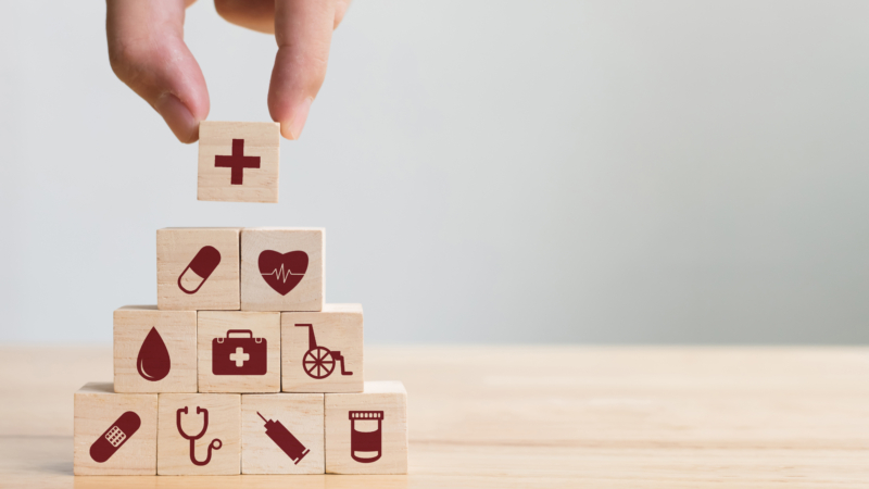 Hand,Arranging,Wood,Block,Stacking,With,Icon,Healthcare,Medical,,Insurance