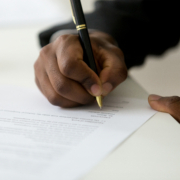 Close,Up,Of,African,American,Worker,Signing,Job,Contract,,Person