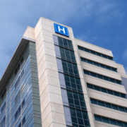 Building,With,Large,H,Sign,For,Hospital