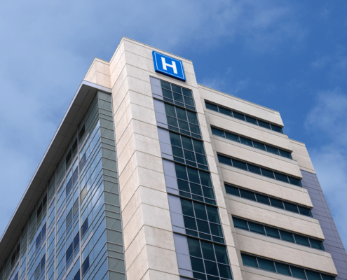 Building,With,Large,H,Sign,For,Hospital