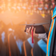 Graduates,Hold,A,Congratulatory,Hat,On,Campus.