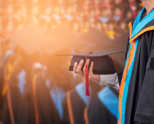 Graduates,Hold,A,Congratulatory,Hat,On,Campus.
