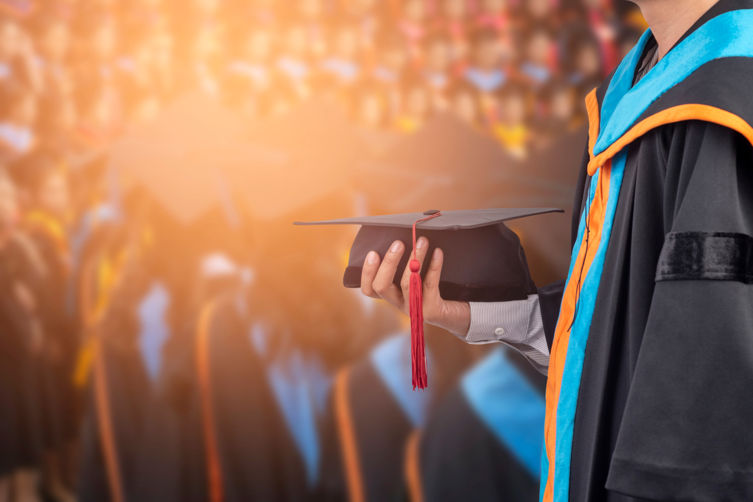 Graduates,Hold,A,Congratulatory,Hat,On,Campus.