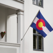 Colorado,Flag.,Colorado,State,Flag,Hanging,On,A,Pole,In