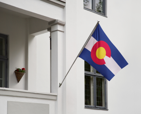 Colorado,Flag.,Colorado,State,Flag,Hanging,On,A,Pole,In