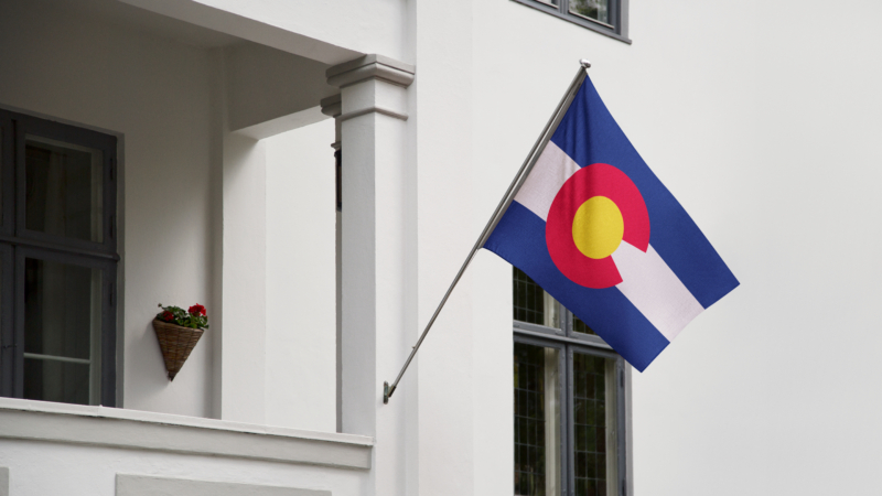 Colorado,Flag.,Colorado,State,Flag,Hanging,On,A,Pole,In