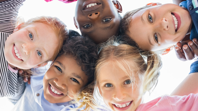 Closeup,Face,Of,Happy,Multiethnic,Children,Embracing,Each,Other,And