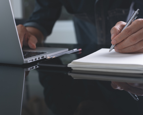 Businessman,Writing,Note,With,Pen,Inspired,Ideas,List,On,Notepad