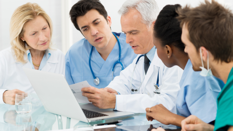 Team,Of,Expert,Doctors,Examining,Medical,Reports,At,Hospital