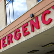 Red,Emergency,Room,Sign,On,The,Side,Of,Hospital,With