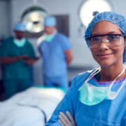 Portrait,Of,Female,Surgeon,Wearing,Scrubs,And,Protective,Glasses,In