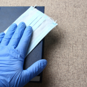 Hand,In,A,Medical,Glove,On,A,Book.,Hippocratic,Oath