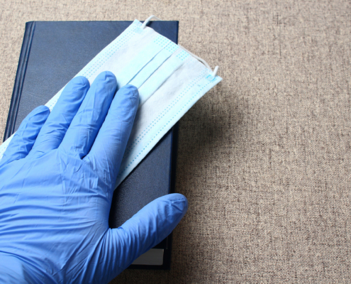 Hand,In,A,Medical,Glove,On,A,Book.,Hippocratic,Oath