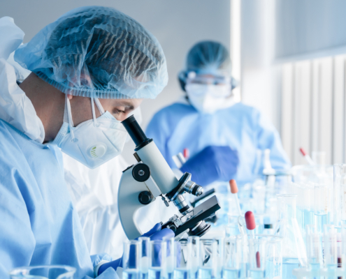 Biochemical,Research,Scientist,Team,Working,With,Microscope,For,Coronavirus,Vaccine