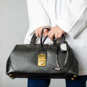 Female,Physician,Holding,A,Black,Leather,Doctor’s,Bag,Heading,To