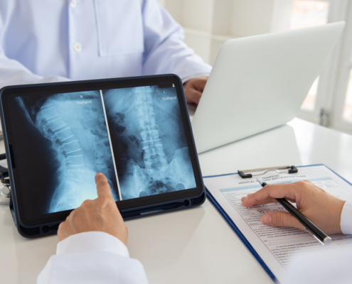 Doctor,Diagnose,Spine,Lumber,Vertebrae,X-ray,Image,On,Digital,Tablet