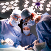 A,Horizontal,Shot,Of,Two,Skilled,Surgeons,And,A,Watchful