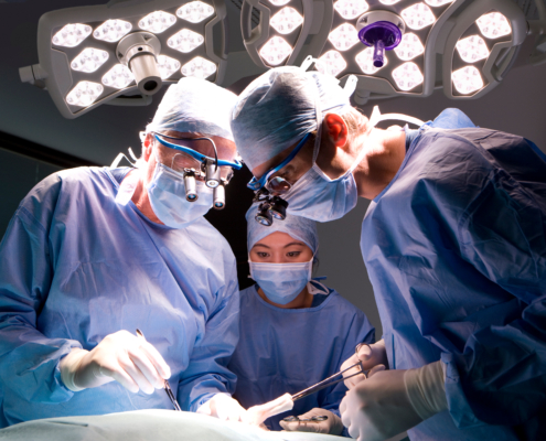 A,Horizontal,Shot,Of,Two,Skilled,Surgeons,And,A,Watchful