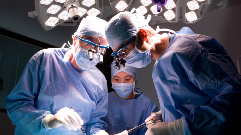 A,Horizontal,Shot,Of,Two,Skilled,Surgeons,And,A,Watchful