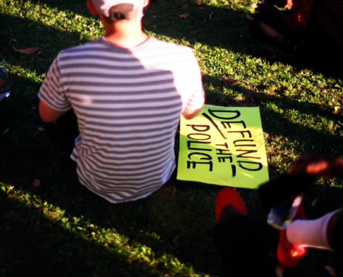 Man,With,Defund,The,Police,Sign