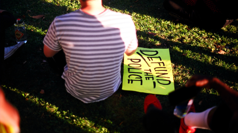 Man,With,Defund,The,Police,Sign