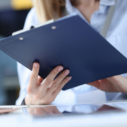 Business,Woman,Holding,Clipboard,With,Documents,In,Her,Hands,At