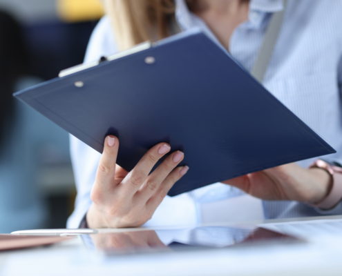 Business,Woman,Holding,Clipboard,With,Documents,In,Her,Hands,At