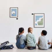 Back,View,At,Diverse,Group,Of,Children,Sitting,On,Floor
