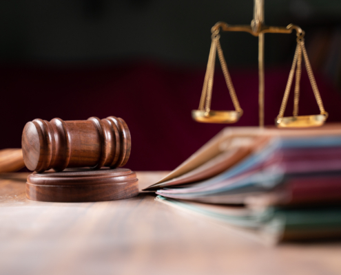 Focus,On,Hammer,,Group,Of,Files,On,Judge,Table,Covered