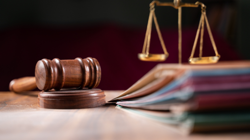 Focus,On,Hammer,,Group,Of,Files,On,Judge,Table,Covered