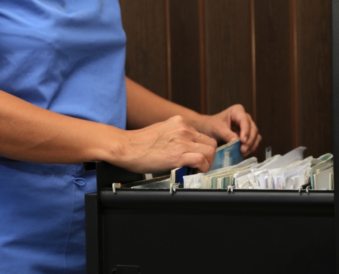 Health,Personnel,In,A,Doctor’s,Office,Looking,For,A,File