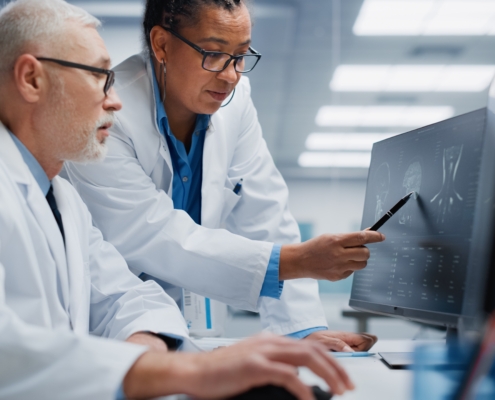 Medical,Hospital:,Neurologist,And,Neurosurgeon,Talk,,Use,Computer,,Analyse,Patient
