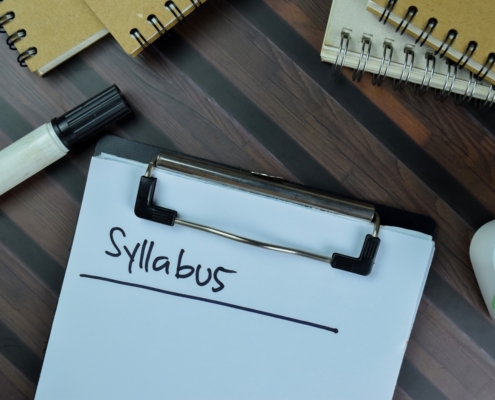 Syllabus,Write,On,A,Paperwork,Isolated,On,Wooden,Table.