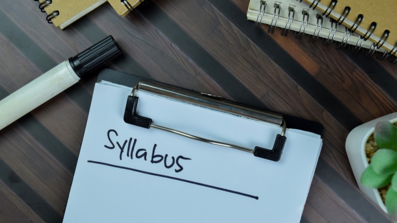 Syllabus,Write,On,A,Paperwork,Isolated,On,Wooden,Table.