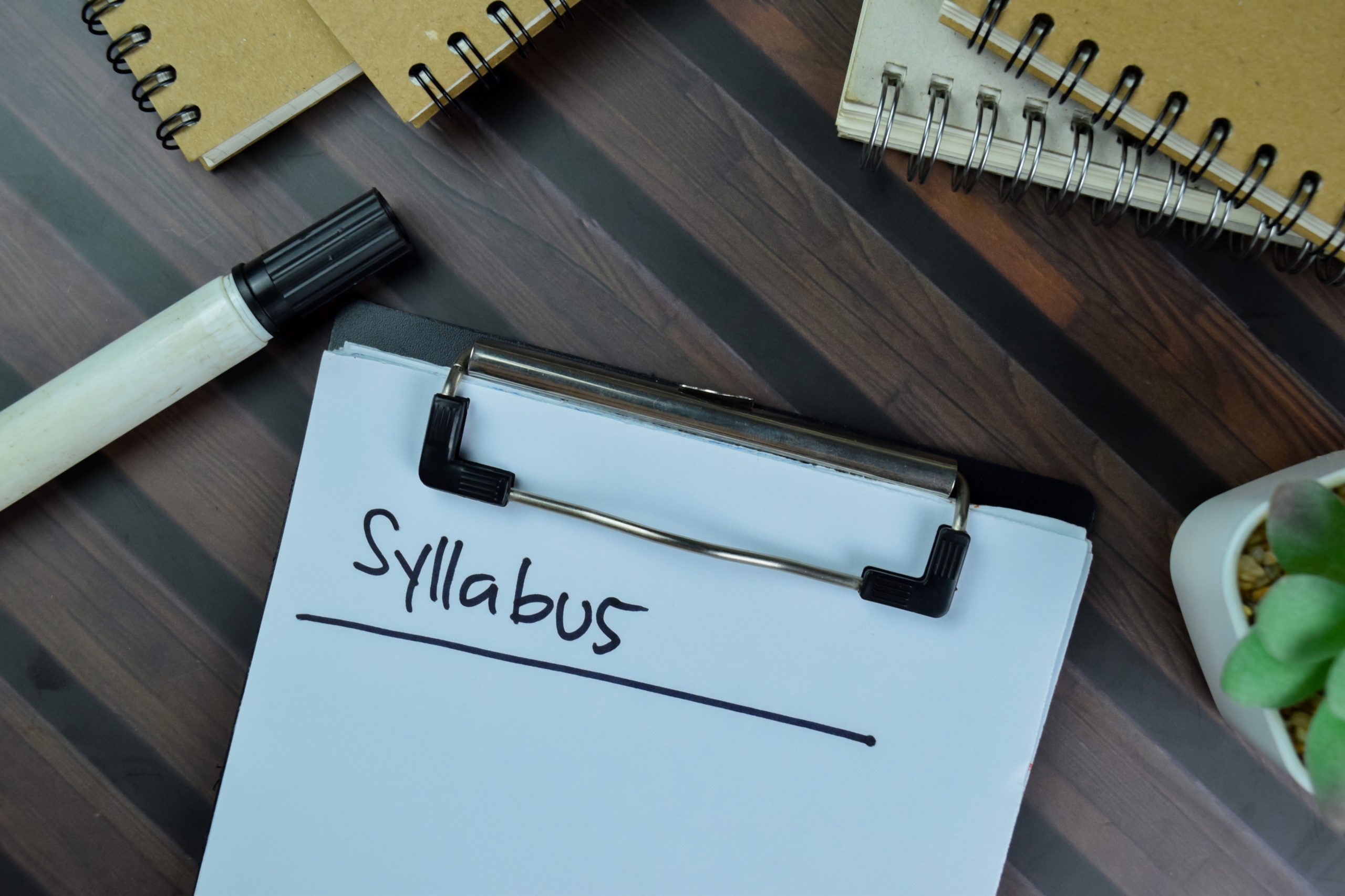 Syllabus,Write,On,A,Paperwork,Isolated,On,Wooden,Table.