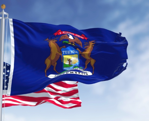 The,Michigan,State,Flag,Waving,Along,With,The,National,Flag