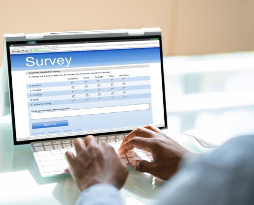 African,Man,Filling,Survey,Poll,Or,Form,On,Laptop,Computer