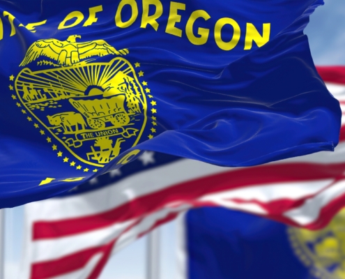 The,Oregon,State,Flag,Waving,Along,With,The,National,Flag