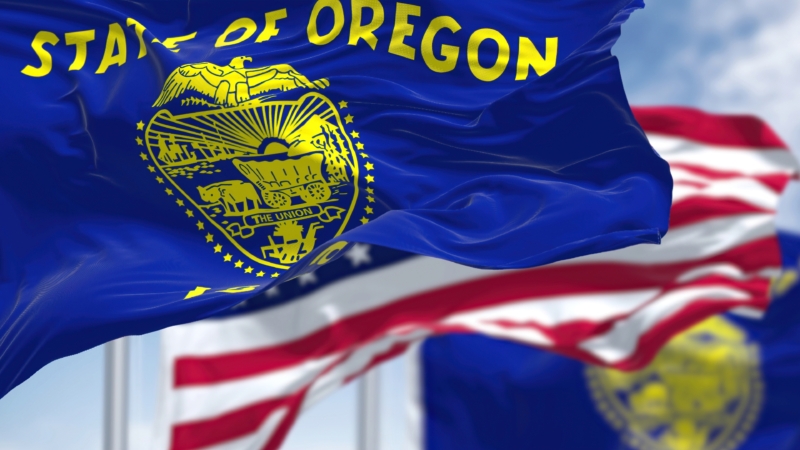 The,Oregon,State,Flag,Waving,Along,With,The,National,Flag