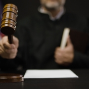 Male,Judge,Hitting,Gavel,,Calling,Court,Members,To,Stand,,United