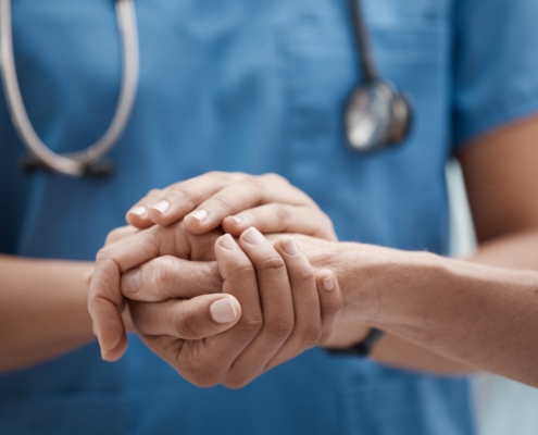 Hand,Holding,,Staff,And,Hospital,Community,With,Trust,,Support,And