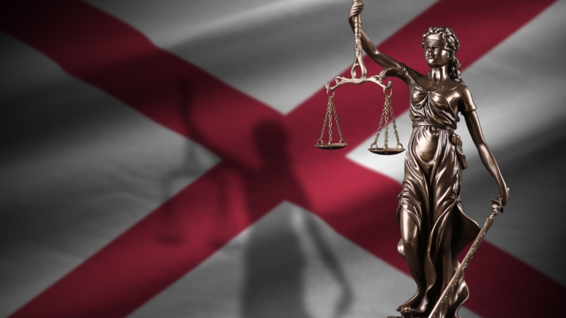 Alabama,Us,State,Flag,With,Statue,Of,Lady,Justice,And