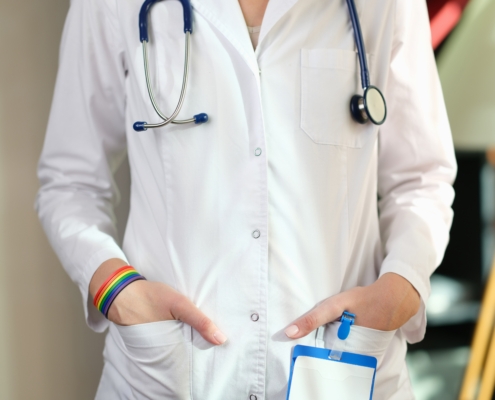 Cropped,Image,Of,Nurse,With,Rainbow,Bracelet,On,Her,Hand.