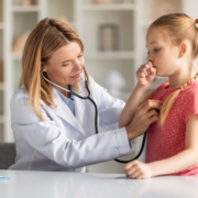 Pediatrician,Lady,With,Stethoscope,Listening,Lungs,Of,Coughing,Little,Girl
