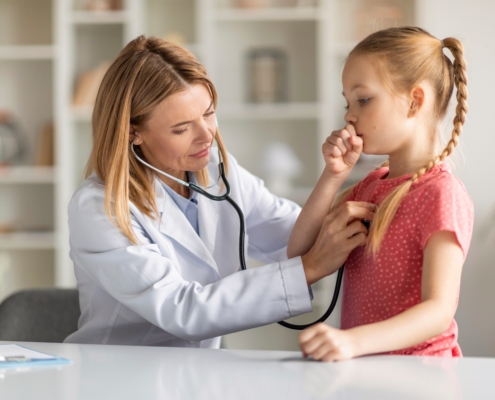 Pediatrician,Lady,With,Stethoscope,Listening,Lungs,Of,Coughing,Little,Girl
