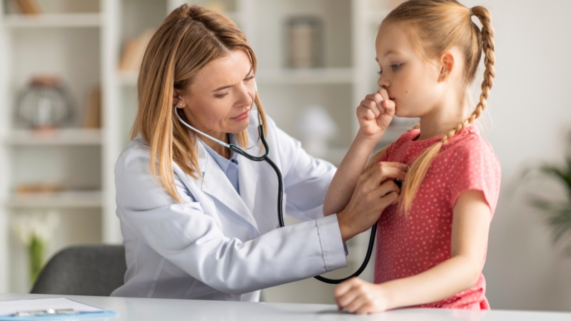 Pediatrician,Lady,With,Stethoscope,Listening,Lungs,Of,Coughing,Little,Girl