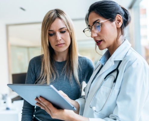 Shot,Of,Beautiful,Female,Doctor,Talking,While,Explaining,Medical,Treatment