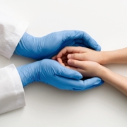 The,Doctor’s,Gloved,Hands,Hold,The,Child’s,Hands.,Medical,Concept.