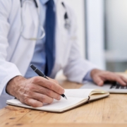 Doctor,,Writing,And,Hands,Of,Notes,With,Computer,And,Medical